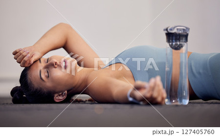 Gym floor, fatigue and woman tired after intense workout, cardio training or yoga fitness exercise. Medical dehydration problem, emergency accident injury and sports athlete faint in pilates studio Gym floor, fatigue and woman tired after intense workout, cardio training or yoga fitness exercise. Medical dehydration problem, emergency accident injury and sports athlete faint in pilates studio 127405760
