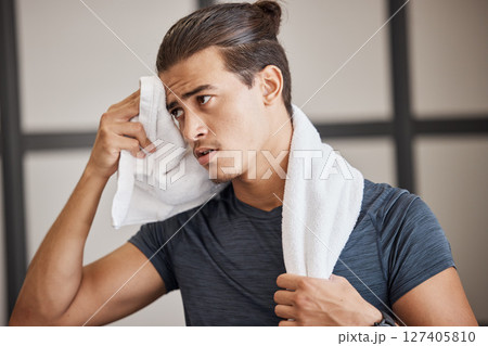 Fitness, man sweat and tired fo exercise, training and fatigue in gym for health and wellness with towel. Man, young and gen z in sport club, healthy or workout with cloth for dry, sweat or skin 127405810