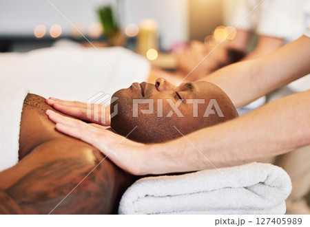 Massage, spa and black man with therapist hands, relax and skincare with zen, peace and wellness on bed. Physical therapy, healing and body therapy, relaxing and luxury treatment with therapist hand 127405989