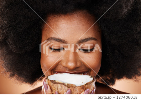 Closeup beauty, coconut and black woman in studio with skincare, healthy glow and smile on face. African, model and natural makeup with fruit for cosmetics, wellness or health with hair by background 127406018