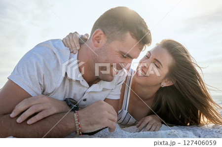 Couple, love and relax on beach sand in summer for romantic vacation break in Australia. Holiday, trust and happy people dating enjoy sunset together with laughter, smile and joy in nature. 127406059