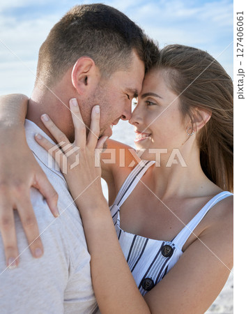 Love, face and couple hug being happy, smile or quality time for vacation, romance or bonding together for holiday. Romantic, man and woman in relationship, date or loving with embrace content or joy 127406061