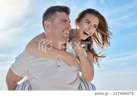 Love, beach and piggy back couple smile with blue sky on romantic summer holiday at ocean. Romance, man and woman have fun at sea for honeymoon, vacation time for happy couple together in Australia. Love, beach and piggy back couple smile with blue sky on romantic summer holiday at ocean. Romance, man and woman have fun at sea for honeymoon, vacation time for happy couple together in Australia. 127406079