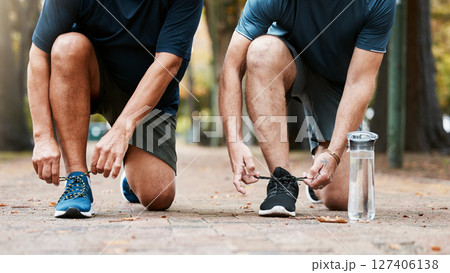 Fitness, run and men friends tying their shoes while doing an outdoor cardio workout in the city. Sports, footwear and male athletes running for exercise or training for marathon, race or competition 127406138