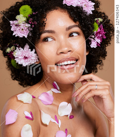 Beauty, makeup or black woman hair with flower portrait in brown studio background for skincare or luxury wellness with smile. Spring model, cosmetics or face of American girl with flowers for summer Beauty, makeup or black woman hair with flower portrait in brown studio background for skincare or luxury wellness with smile. Spring model, cosmetics or face of American girl with flowers for summer 127406343