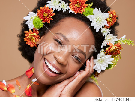 Beauty, art and black woman with flower crown in hair and smile on face, portrait with studio background. Nature, happy woman with flowers, natural skincare or hair care with sustainable ingredients. 127406346