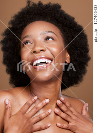 Beauty, skincare and happy black woman in a studio for a health, wellness and cosmetic routine. Happiness, smile and African model with a natural facial, skin or face treatment by a brown background. Beauty, skincare and happy black woman in a studio for a health, wellness and cosmetic routine. Happiness, smile and African model with a natural facial, skin or face treatment by a brown background. 127406438