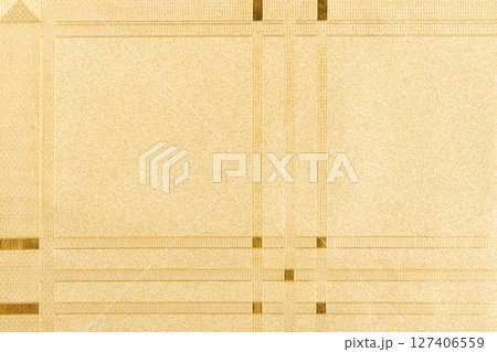 Gold wall texture background. Yellow shiny gold foil paint on wall sheet with gloss light reflection 127406559