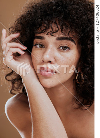 Skincare, hair care and face of woman with beauty, makeup and cosmetics against a brown studio background. Wellness, luxury and portrait of a girl model at a spa or salon for hair or natural skin 127406624