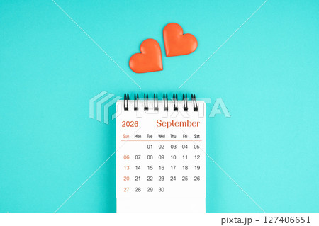 September 2026 desk calendar with red heart on blue color background. 127406651