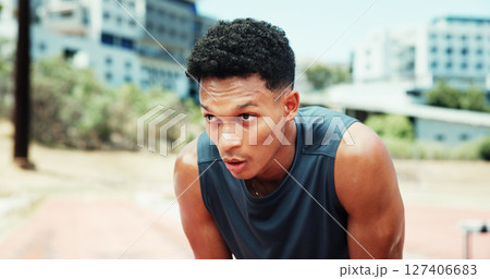 Athlete, man and tired with breathing at stadium for running fatigue, race competition and burnout. Fitness workout, runner or sweating outdoor for marathon recovery, endurance challenge or exhausted 127406683