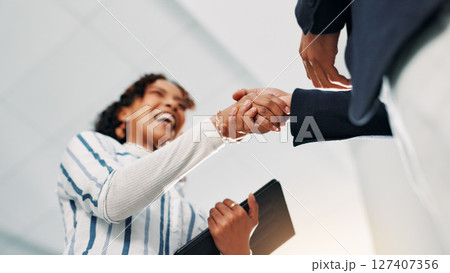 Shaking hands, agreement and business people in office with deal, negotiation or contract. Collaboration, low angle and financial manager with client for partnership, welcome or thank you handshake. 127407356