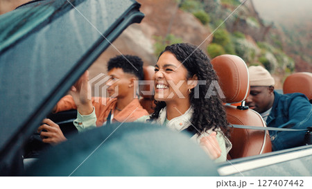 Drive, energy and road trip with happy friends in car together for holiday, travel or vacation. Dance, excited and smile with group of people riding in convertible vehicle for weekend getaway Drive, energy and road trip with happy friends in car together for holiday, travel or vacation. Dance, excited and smile with group of people riding in convertible vehicle for weekend getaway 127407442