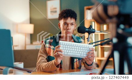 Content creator, keyboard and man live streaming for review, podcast or social media promotion. Filming, product or influencer show technology for advertising, vlog or opinion for gaming gear at home Content creator, keyboard and man live streaming for review, podcast or social media promotion. Filming, product or influencer show technology for advertising, vlog or opinion for gaming gear at home 127407449