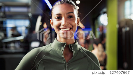 Portrait, healthy and woman with smile in gym, confident and commitment to training routine or workout. Happy, athlete and Indian person with pride for wellness, sportswear or break in fitness center 127407667