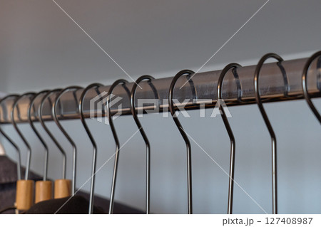 Stylish clothing arranged on hangers in a boutique. High quality photo Stylish clothing arranged on hangers in a boutique. High quality photo 127408987