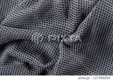 Synthetic polyester fabric macro top view, gray fabric background 127409830