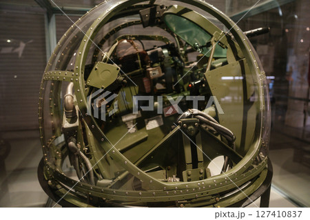 Close-up of the inside of a Grumman ball turret used during World War II. Visible are control systems, wiring, and gunner's aiming mechanisms inside a glass sphere. Close-up of the inside of a Grumman ball turret used during World War II. Visible are control systems, wiring, and gunner's aiming mechanisms inside a glass sphere. 127410837