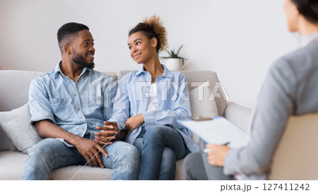 Restored Marriage. Loving Afro Spouses Holding Hands After Successful Marital Counseling With Their Psychologist. Selective Focus Restored Marriage. Loving Afro Spouses Holding Hands After Successful Marital Counseling With Their Psychologist. Selective Focus 127411242
