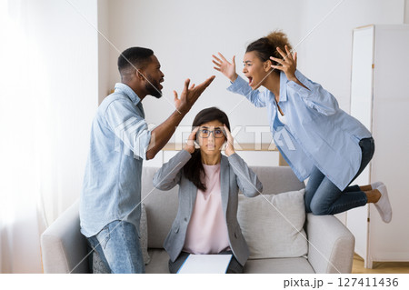 Shocked Marital Therapist Watching Black Couple Shouting And Blaming Each Other On Therapy Session. Selective Focus Shocked Marital Therapist Watching Black Couple Shouting And Blaming Each Other On Therapy Session. Selective Focus 127411436