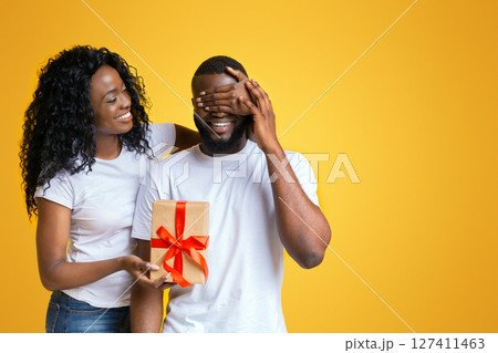 Making gift to boyfreind. African girl with her lover Making gift to boyfreind. African girl with her lover 127411463