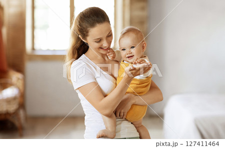 Happy maternity leave time, motherhood concept. Beautiful young mother enjoying pastime with her lovely baby, mom holding adorable little child in her arms and smiling, free space Happy maternity leave time, motherhood concept. Beautiful young mother enjoying pastime with her lovely baby, mom holding adorable little child in her arms and smiling, free space 127411464
