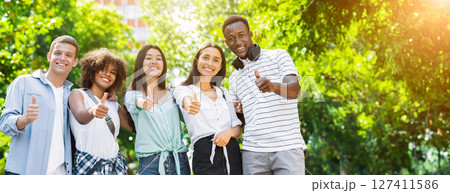 Group Of Multicultural Teen Friends Posing At Camera Outdoors And Gesturing Thumb Up, Panorama 127411586