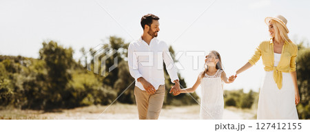 Family walk. Happy family resting in countryside and having fun, talking and laughing 127412155