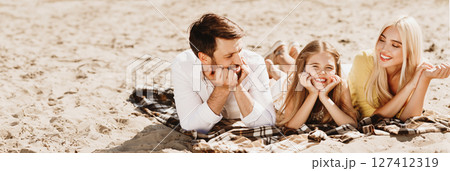 Summer Concept. Family Relaxing Lying On Plaid Having Picnic Outside In Nature Enjoying Sunny Day And After-Quarantine Life. Panorama 127412319