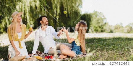 Summer Picnic. Joyful Family Of Three Having Fun Sitting On Blanket In Green Park On Sunny Day After Quarantine. 127412442