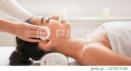 Professional Cosmetologist Cleansing Skin Of Young Asian Woman During Facial Beauty Treatments In Spa, Relaxed Korean Lady Enjoying Wellness Day At Beauty Parlor, Lying In Massage Table, Side View Professional Cosmetologist Cleansing Skin Of Young Asian Woman During Facial Beauty Treatments In Spa, Relaxed Korean Lady Enjoying Wellness Day At Beauty Parlor, Lying In Massage Table, Side View 127413166
