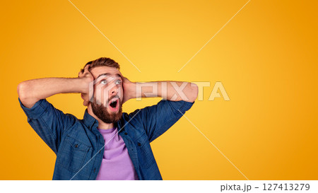 Shocked Caucasian man screaming and grabbing his head in disbelief, looking at blank space on orange studio background. Astonished hipster guy yelling OMG or WOW. Huge sale or promo concept Shocked Caucasian man screaming and grabbing his head in disbelief, looking at blank space on orange studio background. Astonished hipster guy yelling OMG or WOW. Huge sale or promo concept 127413279
