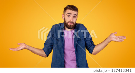 I don't know. Handsome Caucasian guy shrugging shoulders, feeling puzzled or uncertain on orange studio background. Confused millennial man expressing doubt, making difficult choice, panorama I don't know. Handsome Caucasian guy shrugging shoulders, feeling puzzled or uncertain on orange studio background. Confused millennial man expressing doubt, making difficult choice, panorama 127413341