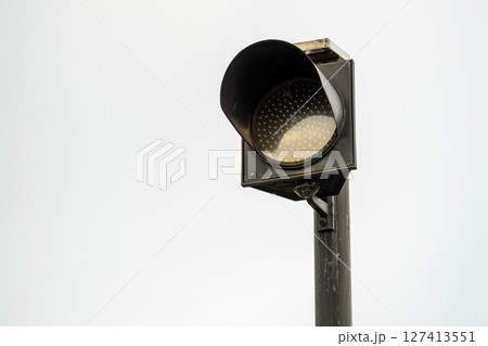 Daylight close-up of traffic light signal at urban intersection for vehicle safety alert Daylight close-up of traffic light signal at urban intersection for vehicle safety alert 127413551