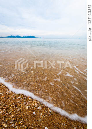 Serene beach waves coastal landscape nature tranquil environment wide angle relaxation concept Serene beach waves coastal landscape nature tranquil environment wide angle relaxation concept 127413873