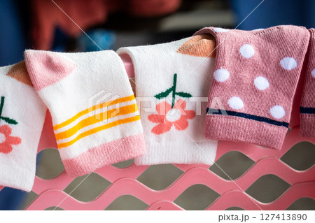 Colorful baby socks displayed a rack home product cozy environment close-up fashion 127413890