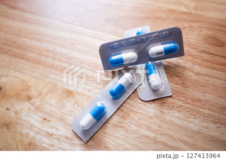Medication capsules wooden surface medicine product close-up clinical use Medication capsules wooden surface medicine product close-up clinical use 127413964