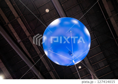 Aerial demonstration of a blue balloon indoor exhibition modern environment upward view aviation concept Aerial demonstration of a blue balloon indoor exhibition modern environment upward view aviation concept 127414015