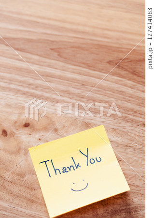 Thank you note wooden table personal gesture home office minimalist environment close-up view Thank you note wooden table personal gesture home office minimalist environment close-up view 127414083