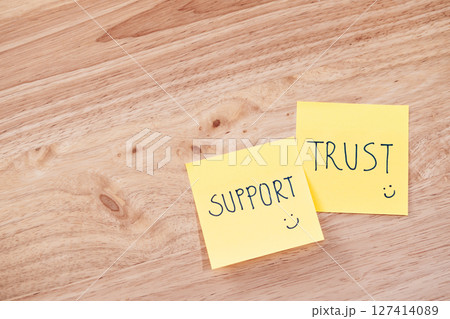 Support and trust in teamwork office space text notes professional setting top view team collaboration 127414089