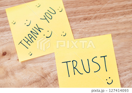 Expressing gratitude and trust positive messages sticky notes in a cozy workspace 127414093