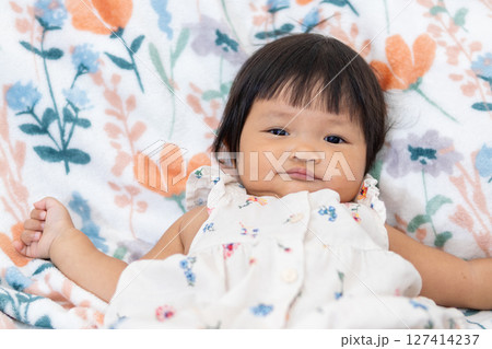 One year old asian girl's adorable moment at home lifestyle portrait soft colors close-up view One year old asian girl's adorable moment at home lifestyle portrait soft colors close-up view 127414237