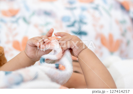 One year old asian girl playing with soft toy at home captivating baby moment indoor bliss 127414257