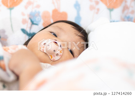 Cuddly baby girl one year old asian indoor nap time in cozy environment close-up view Cuddly baby girl one year old asian indoor nap time in cozy environment close-up view 127414260