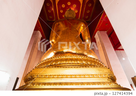 Golden buddha statue temple in thailand cultural icon serene environment rear view spiritual significance 127414394