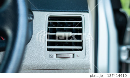 Vehicle interior focus overview of car air conditioning vent system and airflow concept 127414410