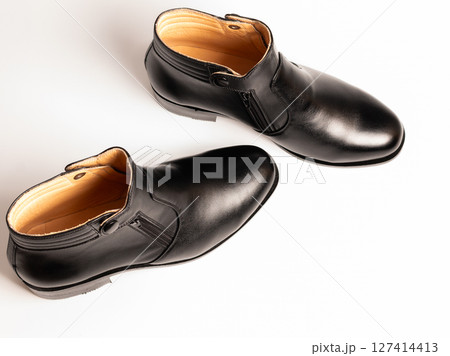 Stylish black leather boots fashion showcase footwear studio setting top view modern lifestyle 127414413