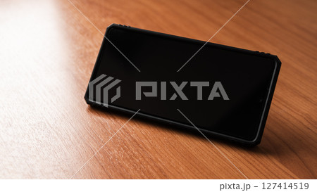 Smartphone wooden surface technology showcase minimalistic environment close-up view 127414519