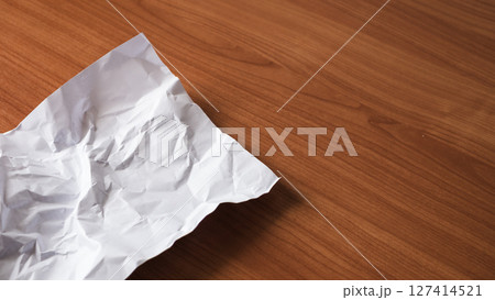 Crumpled paper action desk setting still life minimalist environment close-up view creative concept Crumpled paper action desk setting still life minimalist environment close-up view creative concept 127414521