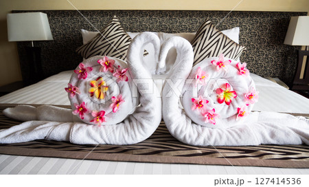 Elegant towel art swans luxury hotel bed relaxing atmosphere romantic setting close-up view Elegant towel art swans luxury hotel bed relaxing atmosphere romantic setting close-up view 127414536